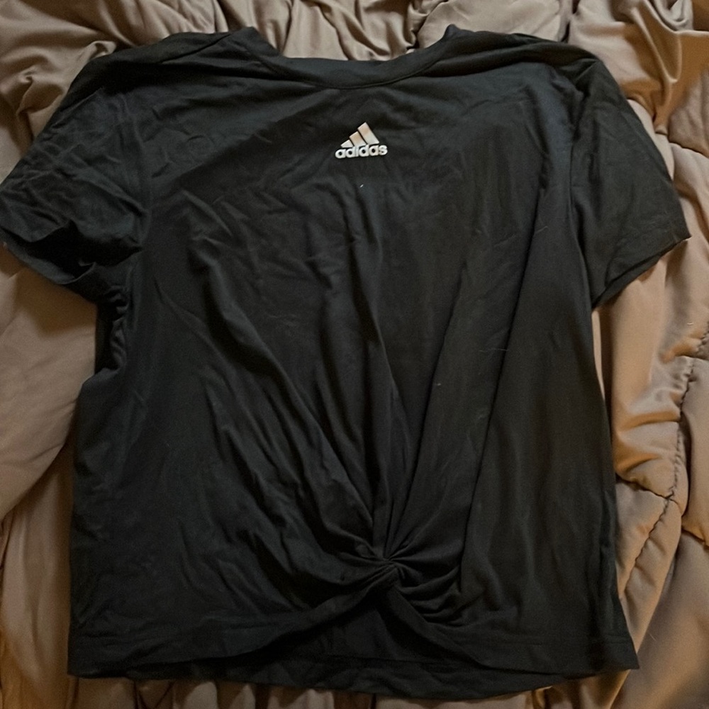 Adidas tshirt with a little knot in the front is a charcoal gray.